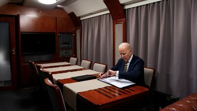 President Joe Biden checks his watch as he goes over his speech marking the one-year anniversary of the war in Ukraine after a surprise visit to meet with Ukrainian President Volodymyr Zelenskiy, Monday, Feb. 20, 2023, in Kyiv. Evan Vucci / Pool via REUTERS