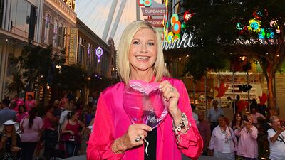 A handout photo made available by the Las Vegas News Bureau shows Olivia Newton-John as she turns the High Roller pink at The LINQ in Las Vegas in honor of Breast Cancer awareness in Las Vegas, Nevada, USA, 06 October 2014 (issued 09 August 2022). Olivia Newton-John died from cancer at the age of 73 at her home in Southern California on 08 August 2022. EPA / STEVE SPATAFORE / LAS VEGAS NEWS BUREAU / HANDOUT Mandatory credit: EPA via Las Vegas News Bureau / Steve Spatafore HANDOUT EDITORIAL USE ONLY / NO SALES