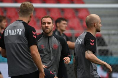 Denmark midfielder Christian Eriksen warms up with teammates before the Finland match. AFP