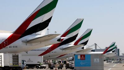 (FILES) In this file photo, an Emirates Airlines Boing 777 plane unloads a coronavirus vaccine shipment at Dubai International Airport on February 1, 2021. - Dubai-based Emirates airline on Tuesday posted a $5. 5 billion annual loss, its first in more than three decades, after the coronavirus pandemic devastated the aviation industry. (Photo by Karim SAHIB / AFP)