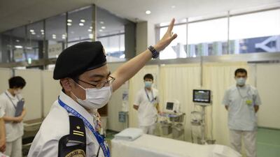 Police officials guide people entering a vaccine centre in Tokyo as the country gears up for inoculation. Getty Images