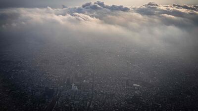 This picture taken from the window of a passenger jet shows an aerial view of the Nakano area of Tokyo on May 21, 2024. (Photo by Yuichi YAMAZAKI / AFP)