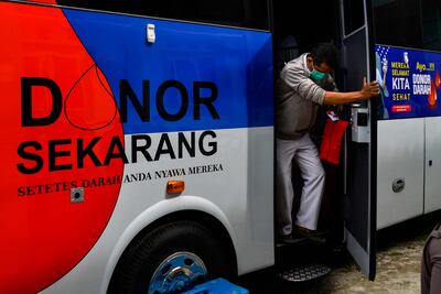 A man leaves a mobile blood donation bus operated by the Indonesian Red Cross on World Blood Donor Day, at a community health centre in Blang Bintang, Aceh province on Monday. AFP