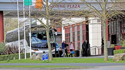 Airline passengers in Dublin leave the bus to enter the Crowne Plaza hotel to begin their period of quarantine. Image: Getty Images