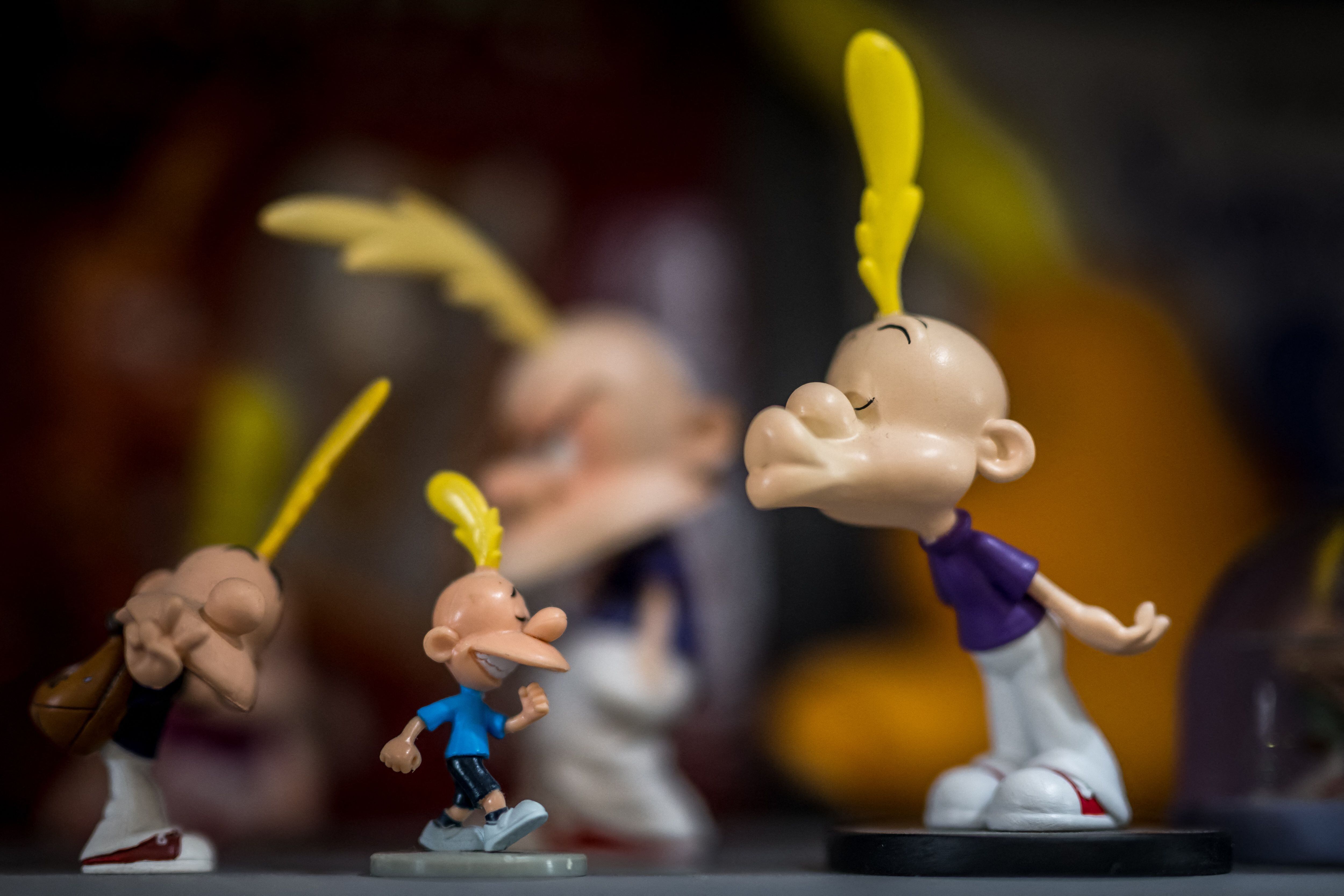 Figurines of the character of Titeuf are seen at the house of Swiss cartoonist Philippe Chappuis better known as Zep during an interview with AFP in Geneva, on May 1, 2024. "Comics have become my profession and music has always been my hobby and for several years it has taken up more space". More than 30 years after creating the famous comic book character Titeuf, Swiss cartoonist Zep explores his other passion, music, in a pop-folk album. (Photo by Fabrice COFFRINI / AFP)