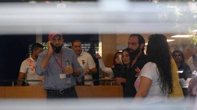 Lebanese depositors inside a Blom Bank branch in Beirut. A group of customers, at least one of whom was armed, took hostages in the bank, demanding access to their savings. They were reportedly able to withdraw $20,000 from an account of one of the depositors before they left. EPA