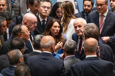 Russia's UN Ambassador Vassily Nebenzia, and China's ambassador Zhang Jun, centre left, speak with ambassadors of Arab countries before a Security Council meeting in New York. AP