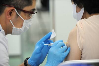 TOKYO, JAPAN - JUNE 09: A medical worker administers a dose of COVID-19 vaccine at the mass vaccination center on June 09, 2021 in Tokyo, Japan. According to the health ministry of Japan, as of June 8, 2021, approximately 19 million COVID-19 vaccine shots have been administered, increasing about 1 million from the previous day. (Photo by David Mareuil - Pool / Getty Images)