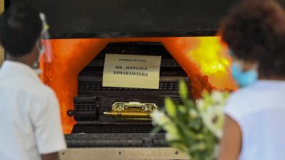 The ocffin of Sri Lanka's former foreign minister Mangala Samaraweera, who died today due to the Covid-19 coronavirus, is seen during the cremation at Colombo's main cemetery on August 24, 2021. (Photo by ISHARA S. KODIKARA / AFP)