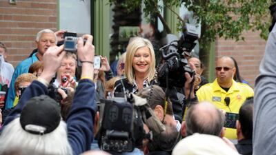 A handout photo made available by the Las Vegas News Bureau shows Olivia Newton-John (C) arriving at the Flamingo in Las Vegas, Nevada, USA, 02 April 2014 (issued 09 August 2022). Olivia Newton-John died from cancer at the age of 73 at her home in Southern California on 08 August 2022. EPA / BRIAN JONES / LAS VEGAS NEWS BUREAU / HANDOUT Mandatory credit: EPA via Las Vegas News Bureau / Brian Jones HANDOUT EDITORIAL USE ONLY / NO SALES